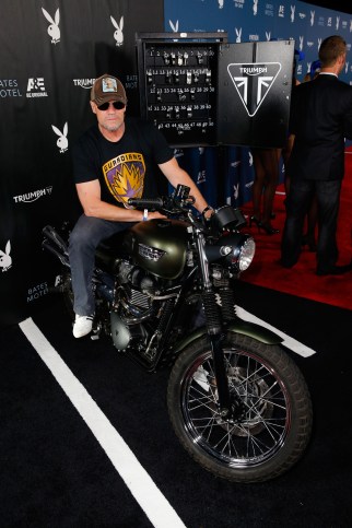 SAN DIEGO, CA - JULY 25: Actor Michael Rooker attempts to start the engine for charity of the Triumph Scrambler Custom on display at the Playboy and A&E Bates Motel Event During Comic-Con Weekend, on July 25, 2014 in San Diego, California. (Photo by Joe Scarnici/Getty Images for Playboy)